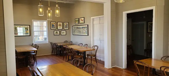 The Hadden Cottage private dining room with colorful artwork and pendant lights