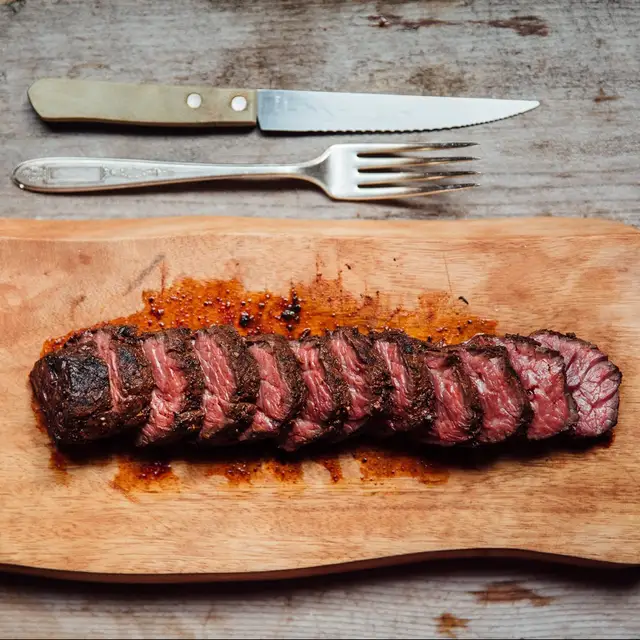 Sliced steak on a cutting board