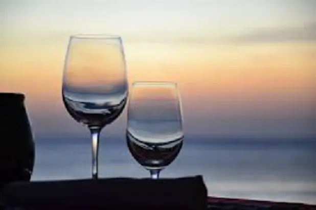 Wine glasses at sunset over Lake Pontchartrain